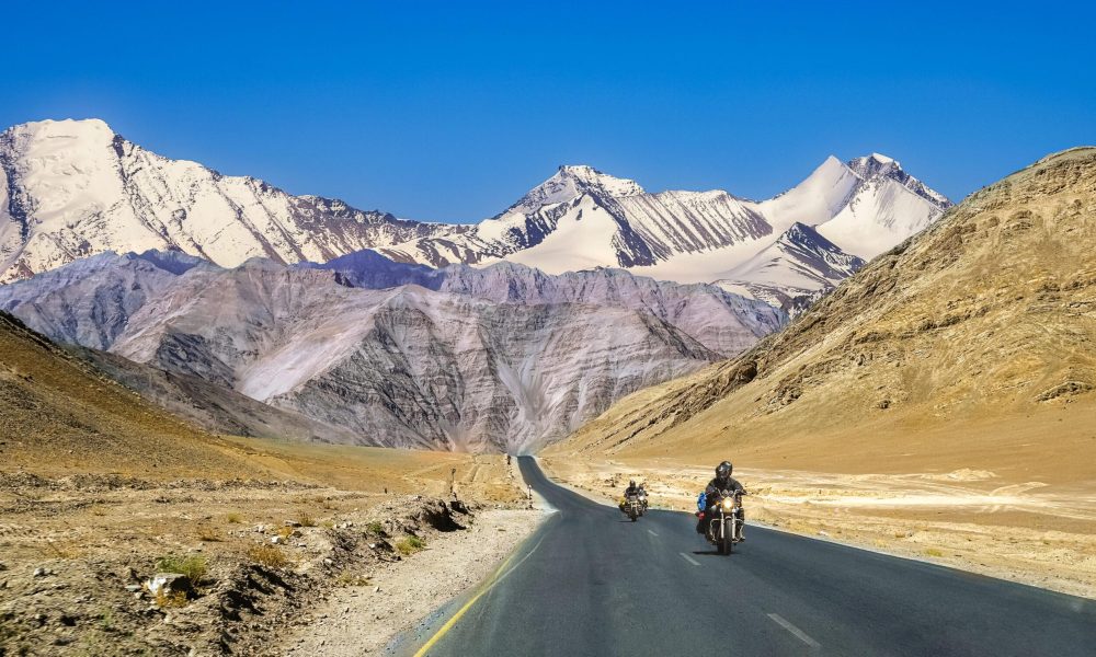 Indian bikers travel on national highway with scenic landscape at Ladakh India. Indian tourists enjoy bike ride on national highway with scenic landscape at Ladakh India.